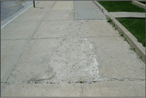 A cement slab that contains cracks and erosion.
